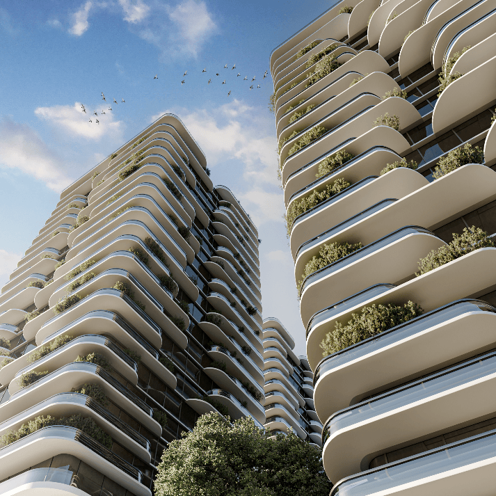This upward view highlights the project’s signature language: rounded balcony slabs wrapping the corners and extending in smooth horizontal layers. Integrated planting along the terraces introduces a “vertical garden” effect that breaks the glass mass and adds texture at close range. The composition reinforces a sense of shelter and privacy, while the façade depth suggests shading performance and visual comfort in bright climates.